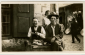 Two men and a girl in a marketplace, Lviv, ca. 1930. The poster on the wall behind the girl advertises the Yiddish newspaper Togblat (Daily Paper). ©YIVO Photo Archive