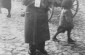 Majer Sztajman poses on a cobblestone street in the Opatów ghetto holding his baby daughter, Mania. Taken around 1942 © United States Holocaust Memorial Museum, Courtesy of Marion Weinzweig