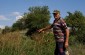 Pavel P., born in 1932, showing to the Yahad team the killing site of 800 Jews, murdered on March 10, 1942, by German colonists. The victims were executed in a lime pit located on a hill on the outskirts of Marianivka. ©Svitlana Kovaliova/Yahad - In Unum