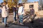 Yahad’s team near the former Jewish school building with a local witness. © Les Kasyanov/Yahad-In Unum.