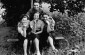 Four Jewish teenagers wearing armbands pose outside on a bench in the Konskie ghetto.© United States Holocaust Memorial Museum, courtesy of Herman Neudorf