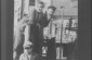 A couple poses on the balcony of their butcher shop, (in the photographer's words) "taking the May air."  1920s-30s © From the Archives of the YIVO Institute for Jewish Research