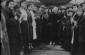 At the ’khupe’ (ceremonial wedding canopy) at an outdoor wedding. The bride (center) faces us between two rows of celebrants holding lit candles.January 1924 © From the Archives of the YIVO Institute for Jewish Research