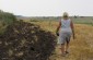 Valentyna A., born in 1951, leads the Yahad team to the livestock pit in which the Jewish people brought through Demydivka who died along the way were buried. ©Svitlana Kovaliova/Yahad - In Unum